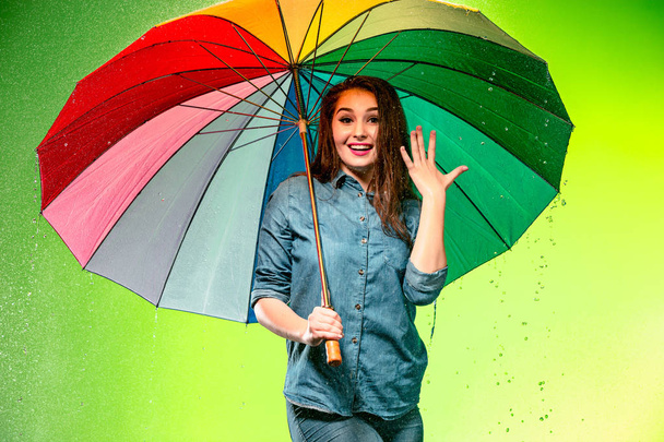 Young beautiful woman with an umbrella. - Zdjęcie, obraz