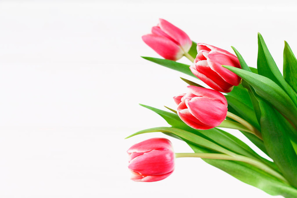 Bouquet of pink tulips on white wooden background. Top view, copy space. Happy mother's day. - Zdjęcie, obraz