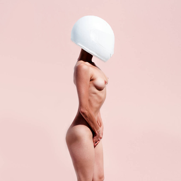 Fashion Model Nude in a helmet. Minimal art surreal - 写真・画像