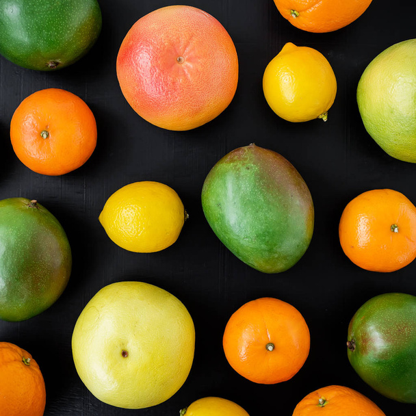Fruit background. Fresh fruits on black  background. Flat lay, top view. - 写真・画像
