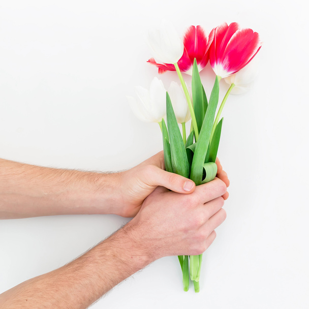 Hands holding tulips bouquet - Фото, зображення