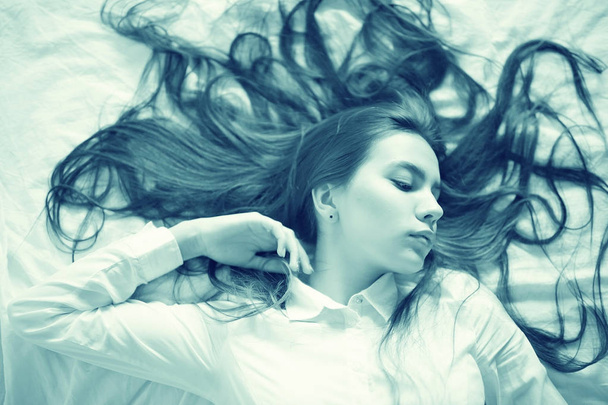 teenage girl with long hair in bed - Fotografie, Obrázek