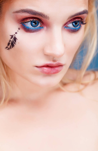 Young woman with exotic make up. - Fotó, kép