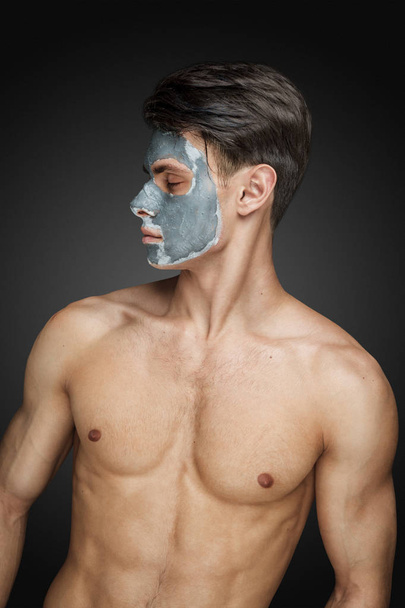 man with cleaning clay facial mask - Foto, Imagem