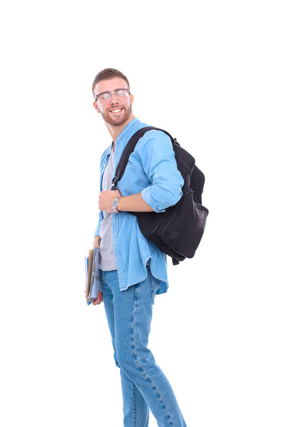 Young male student with school bag holding books isolated on white background - Foto, Imagem