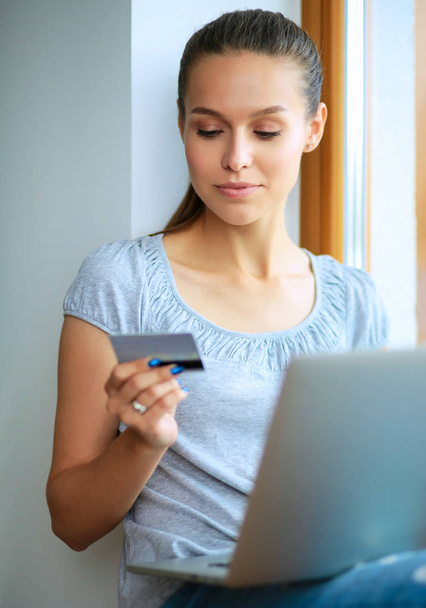 Young beautiful woman using a laptop computer at home - Photo, image