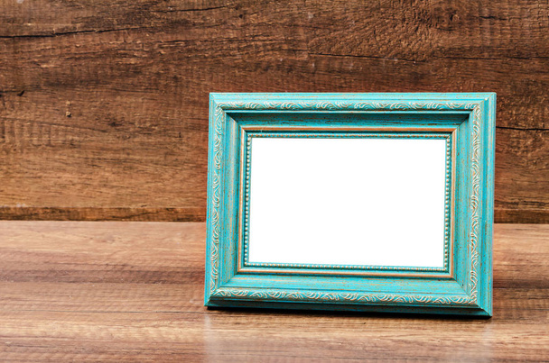 Blue blank photo frame on wooden room. - Valokuva, kuva