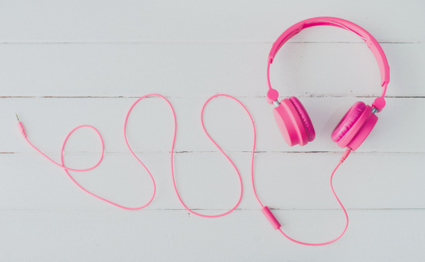 Pink headphones on the wooden floor - Photo, Image