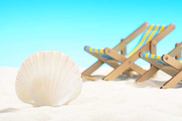 Seashell y dos tumbonas en la playa en el fondo del cielo azul
 - Foto, imagen