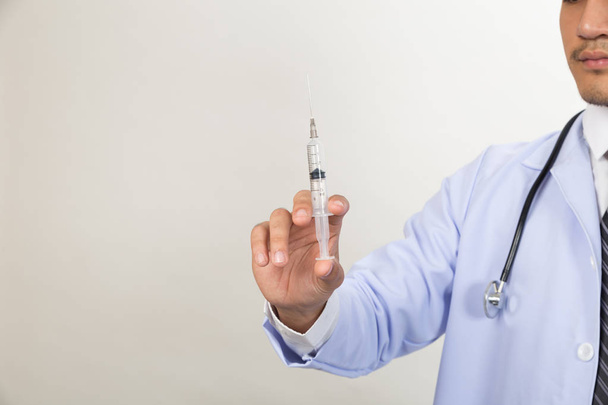 Doctor with syringe is preparing for medical injection - Φωτογραφία, εικόνα