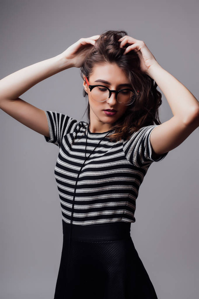 Fashion portrait pretty sweet young woman over grey background - 写真・画像