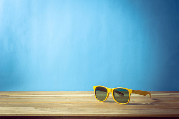 accessories for summer on wooden blue background - 写真・画像