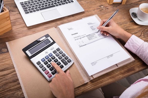 Businesswoman Calculating Tax  - Foto, Bild