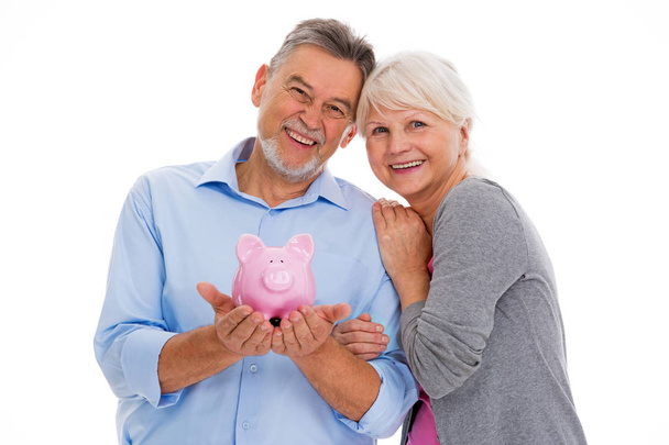 Senior couple holding piggy bank - Foto, immagini