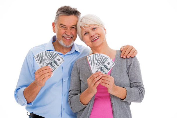 Smiling senior couple holding money - Fotó, kép