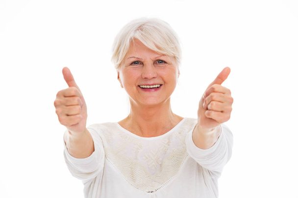 Senior woman showing thumbs up - Valokuva, kuva