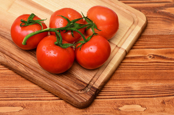 Tomatoes. cherry on vine on cutting board. brown vintage background - Foto, Imagem