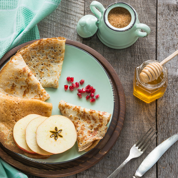 Tasty traditional russian breakfast of pancakes with honey on plate. Rustic style. - Foto, immagini