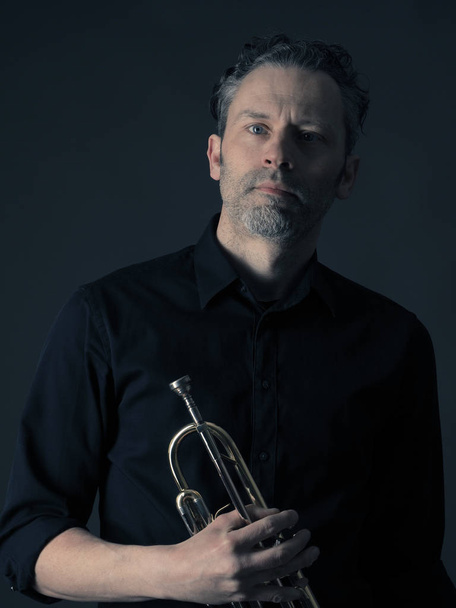Dark portrait of a brass musician - Photo, Image