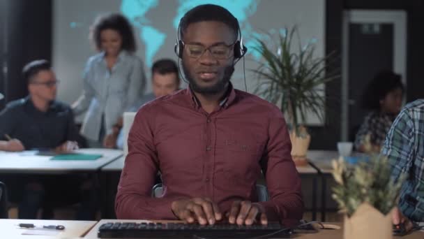 Cheerful men call center operator at work - Footage, Video