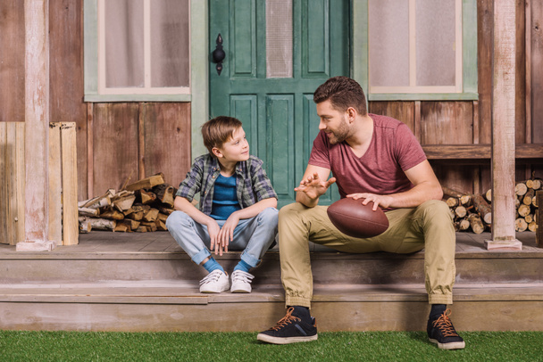 father with son sitting on porch  - Photo, image