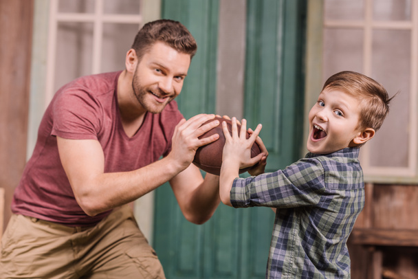 father with son playing with ball at backyard - Photo, Image