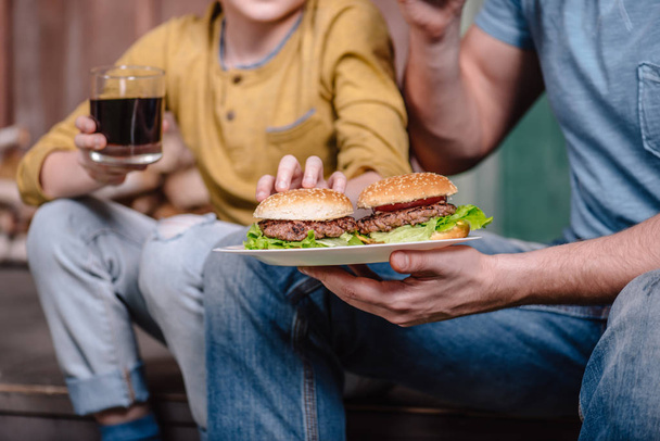 father and son with homemade burgers - Photo, Image