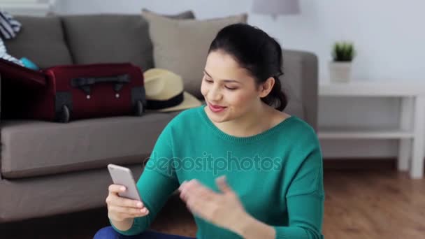woman with smartphone and travel stuff at home - Footage, Video
