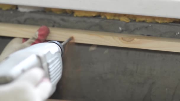 Electric drill drills wall and tree, close up, repairs in house - Footage, Video