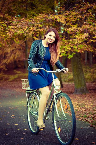 Girl in dress on bike. - Foto, Imagen