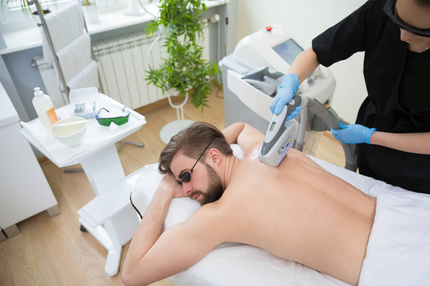 IPL therapy at men's back - Foto, immagini