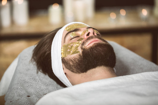 Men's gold mask therapy at beautician's - Φωτογραφία, εικόνα