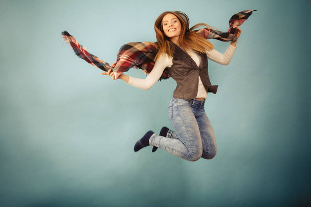 Woman fashion autumn girl jumping, flying in air on blue - 写真・画像