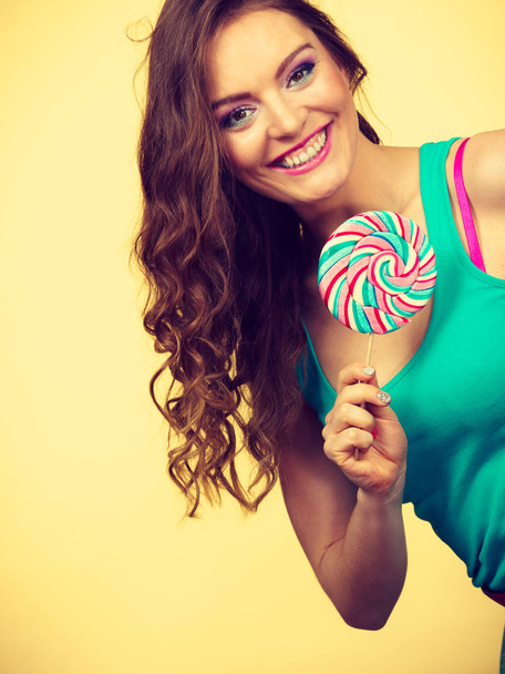 Woman charming girl with lollipop candy - Valokuva, kuva