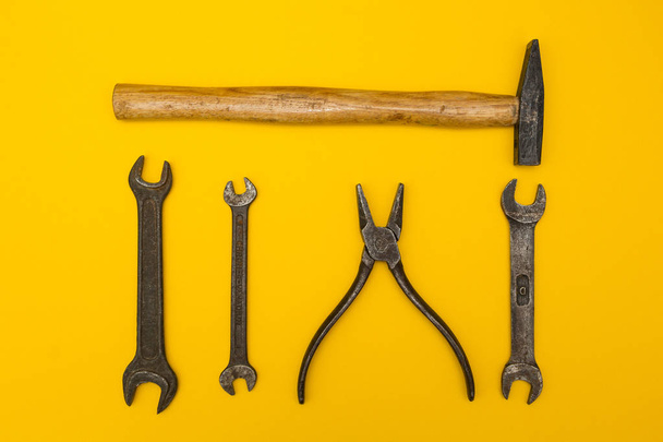 Old rusty tools on a yellow background. - Foto, immagini