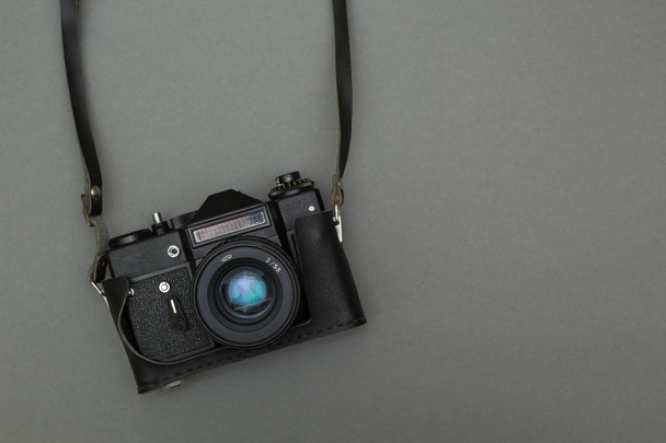 Retro photo camera on a strap - Фото, зображення