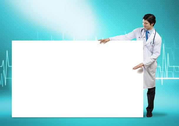 Doctor with white blank banner - Φωτογραφία, εικόνα