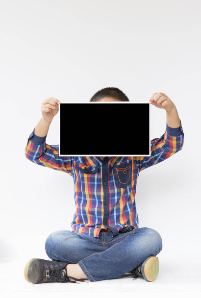 Child with blank or mock up in his hands on isolated.. - Photo, image