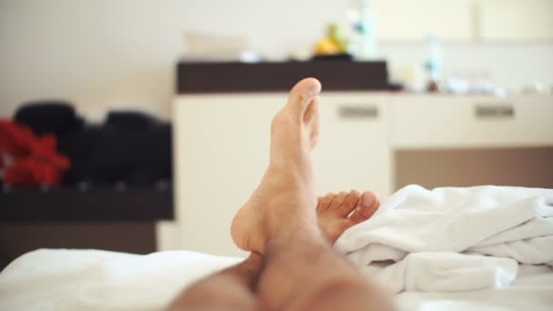 mens legs on bed in bedroom - Footage, Video