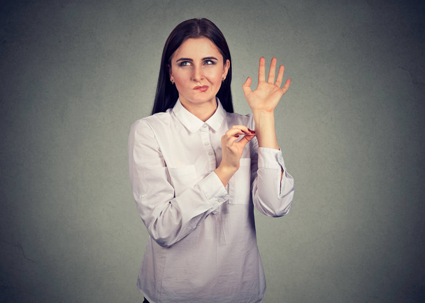 Confused woman pinching herself in disbelief of what just happened   - 写真・画像