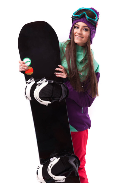 красивая женщина в лыжном костюме с сноубордом
 - Фото, изображение
