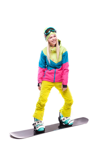 woman in ski suit rides snowboard - Photo, Image