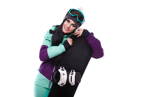 Frau im lila Skikostüm mit Snowboard - Foto, Bild