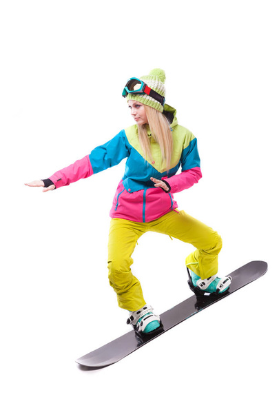 woman in ski suit rides snowboard - Фото, зображення
