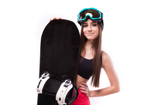 Schlanke junge Frau hält Snowboard - Foto, Bild