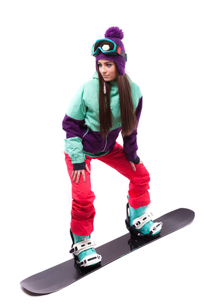woman in purple ski rides snowboard - Zdjęcie, obraz