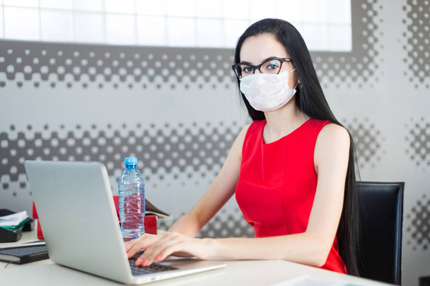 Business woman wearing mask in office - Фото, изображение