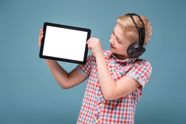 boy with headphones holding digital tablet - Photo, Image