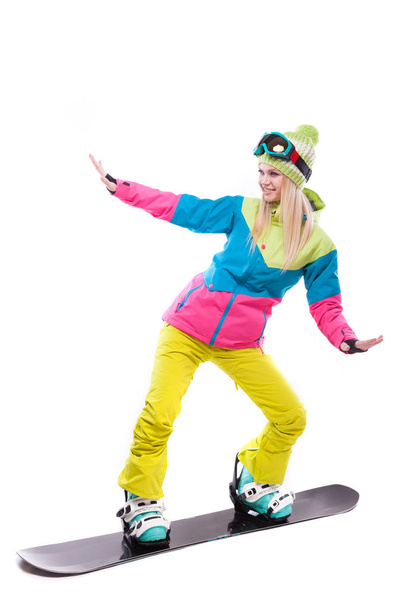 vrouw in ski pak rijdt snowboard - Foto, afbeelding