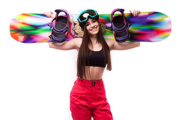 slim young woman holds snowboard - Фото, изображение